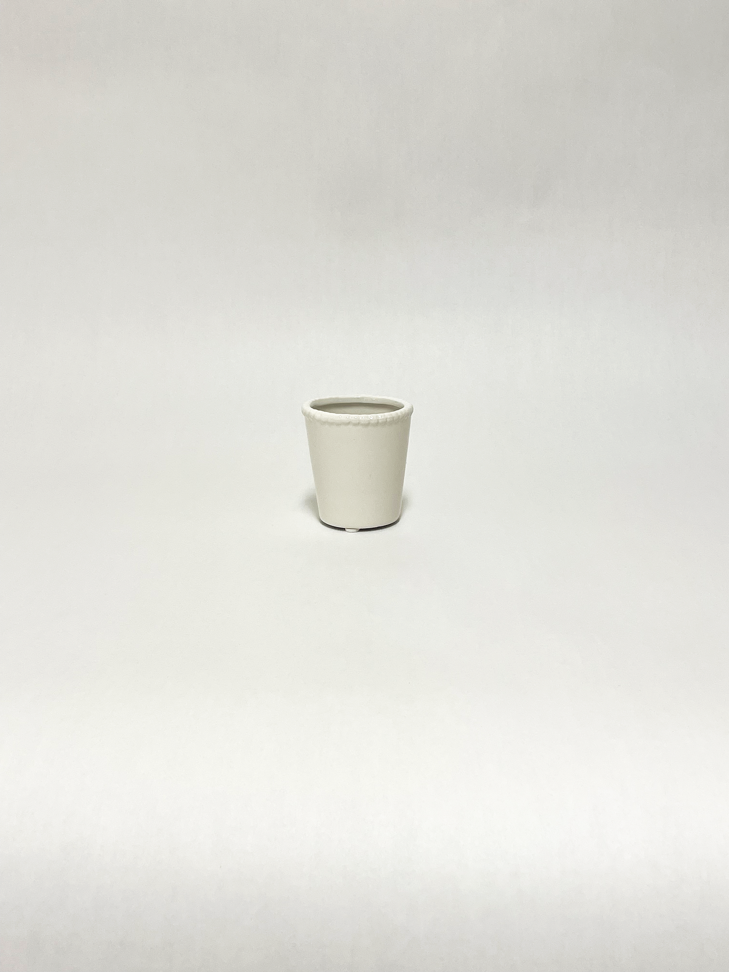 small white pot with beaded rim